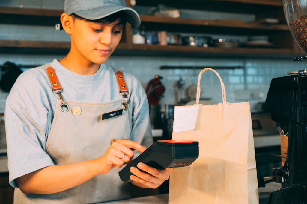 Man in Blue and White Crew Neck T-shirt Holding Black Smartphone